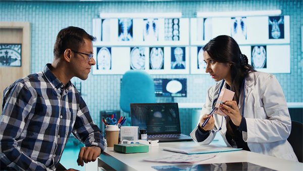 A doctor talking to a patient in a neurological care setting