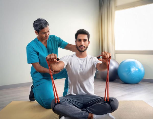 A physiotherapist helping a patient with orthopedic rehabilitation