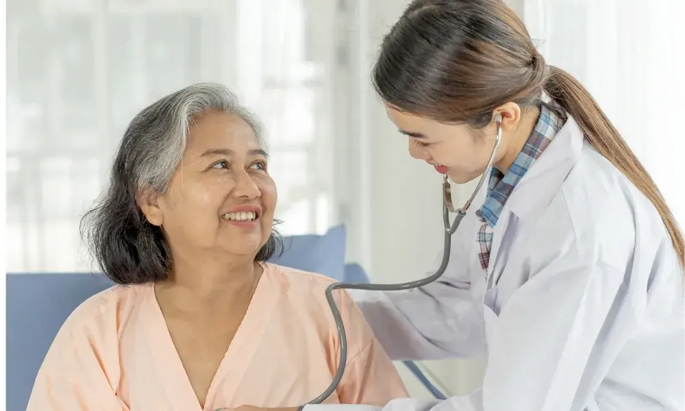 A home care attendant sharing a joyful moment with a senior person