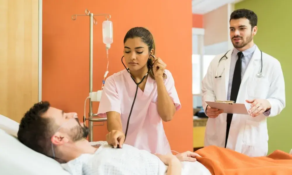A home care attendant assisting a patient in a comfortable home setting