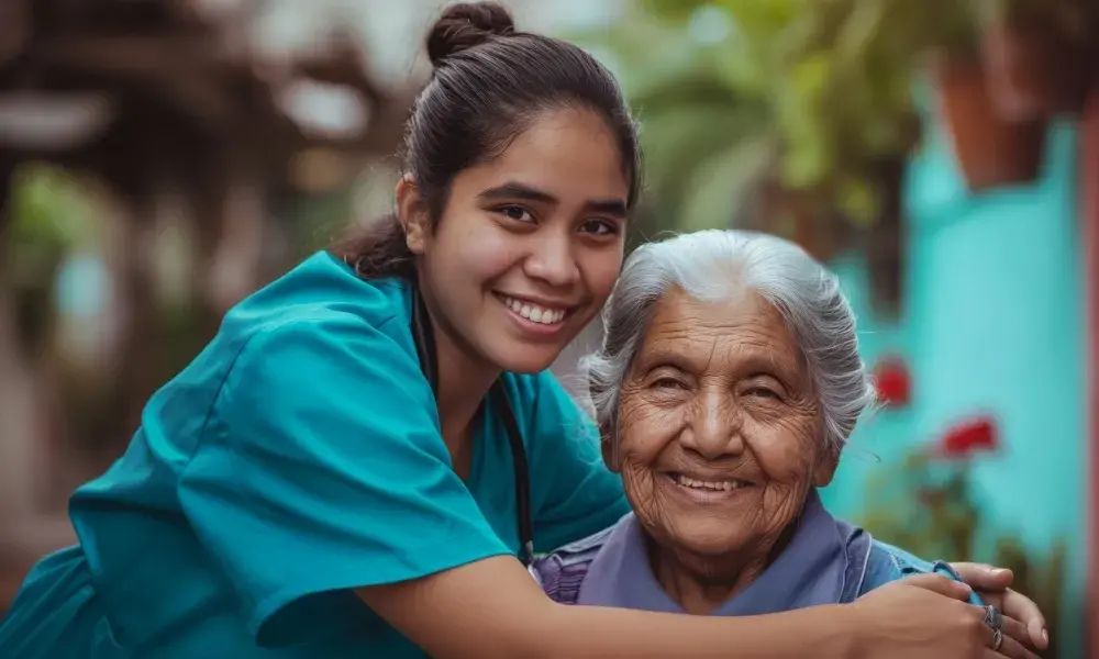 A compassionate nurse tending to a smiling senior patient